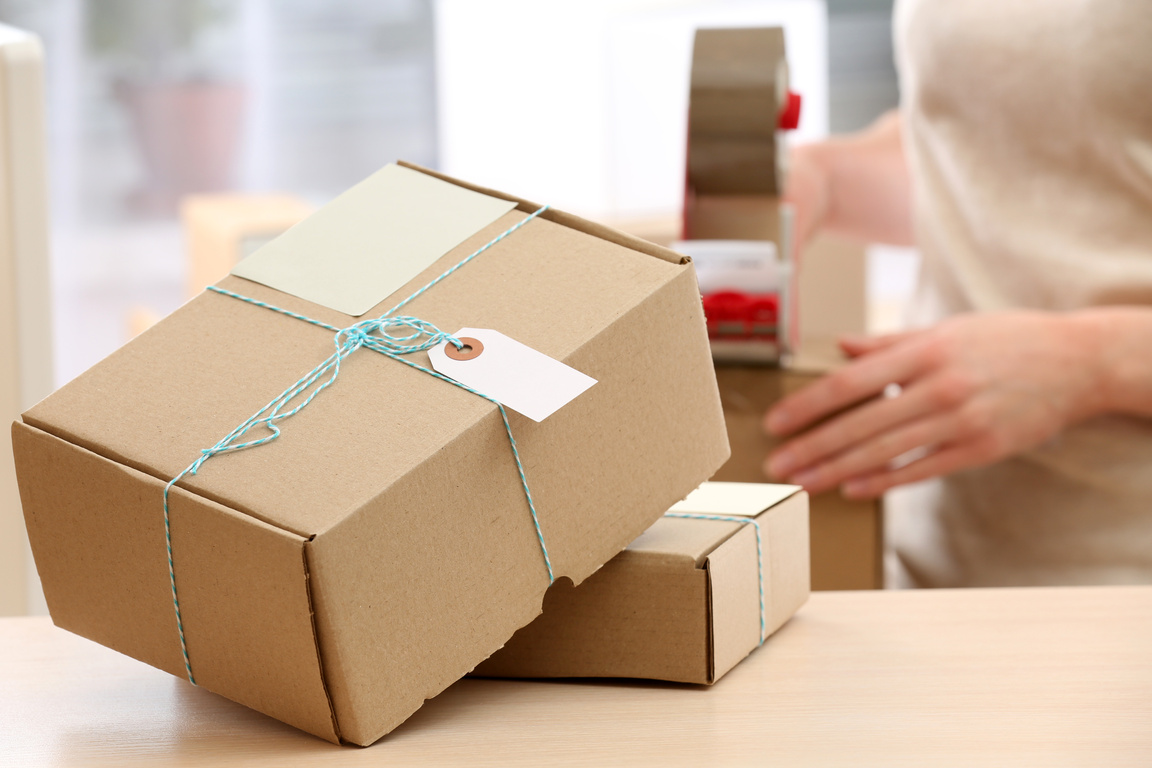 Woman Packs Parcel in Post Office